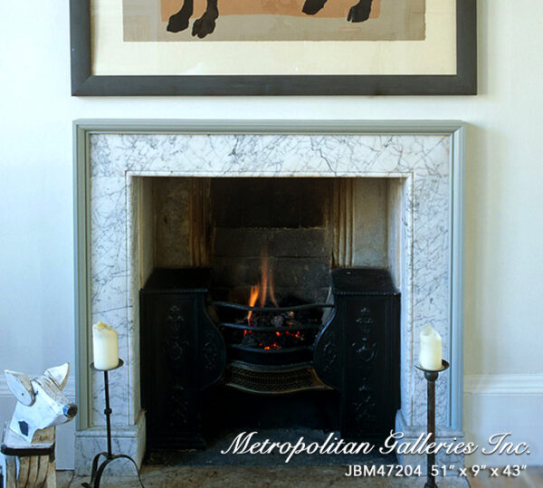 Artwork above open fireplace with lit fire